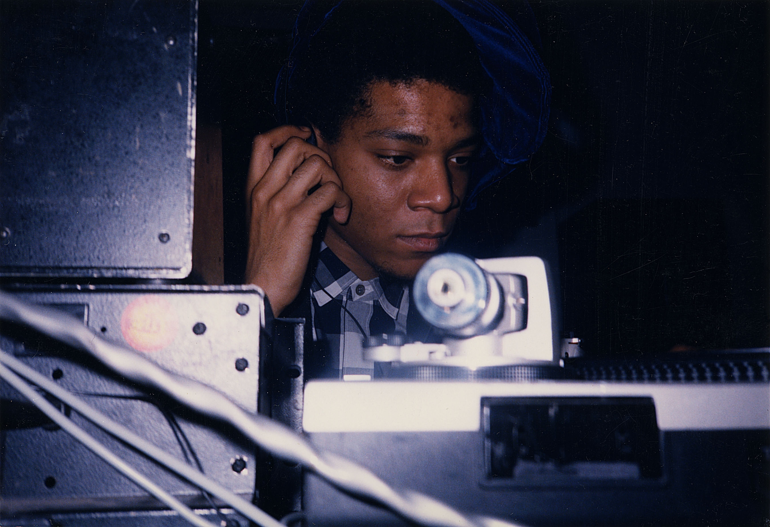 Jean-Michel Basquiat DJ-ing in the lounge at Area, 1986. Photograph by and courtesy of Johnny Dynell.